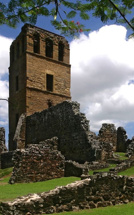 Ruins of Panama Viejo showcasing a historic stone tower placed beneath bright blue skies near Megapolis Hotel Panama