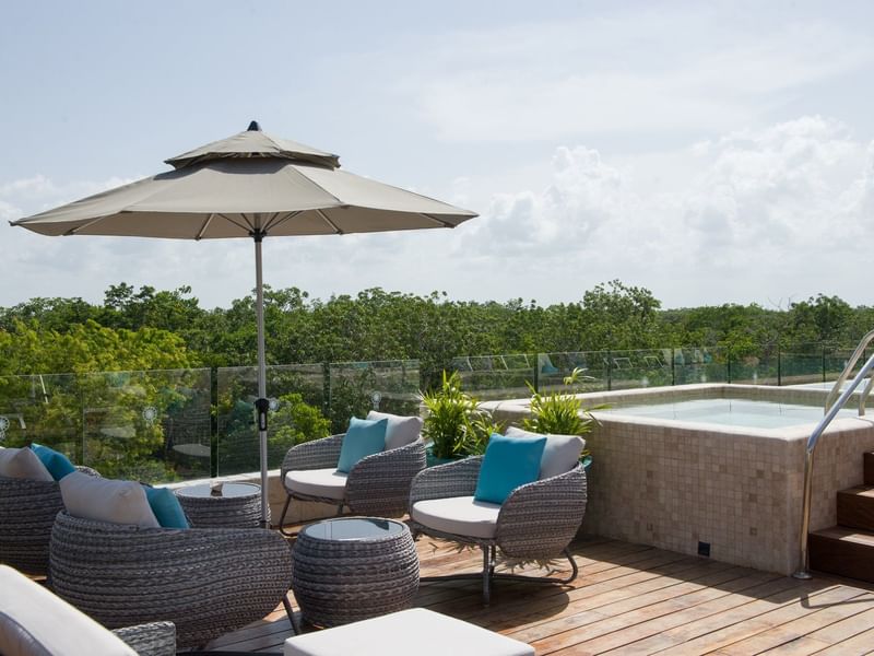 Lounge chairs & umbrella by the pool at Naay Tulum Curamoria