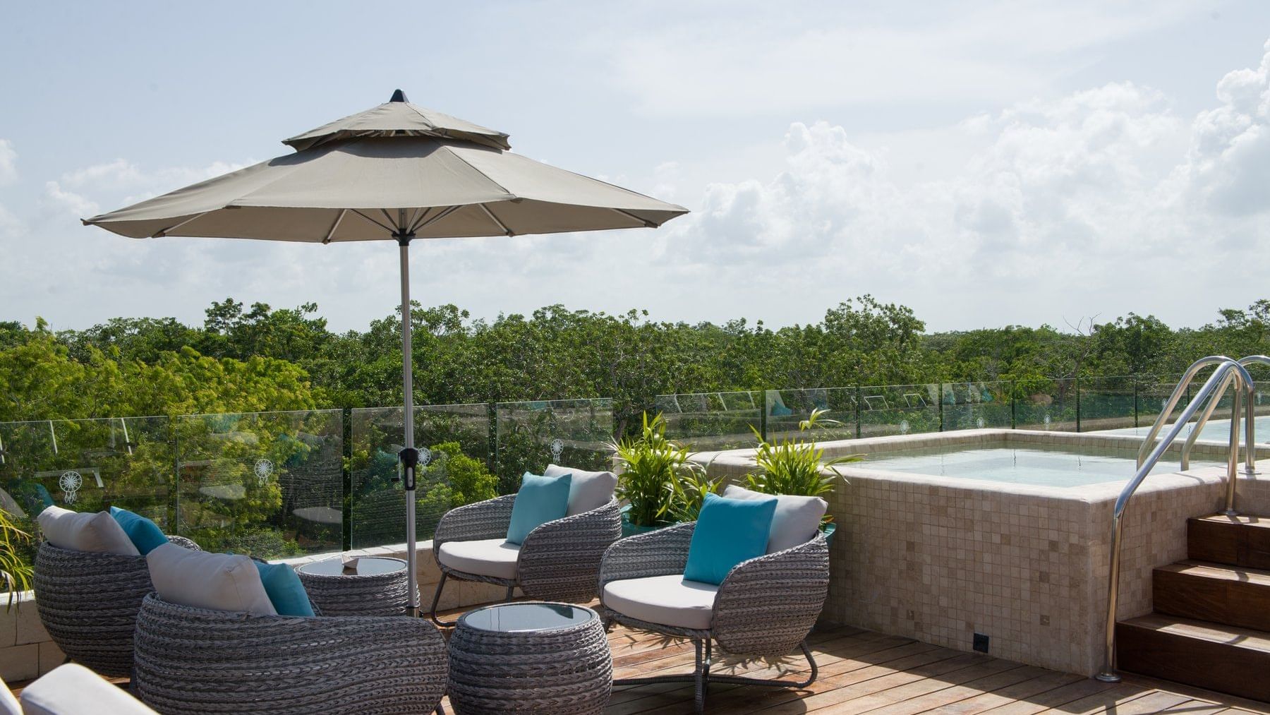 Lounge chairs & umbrella by the pool at Naay Tulum Curamoria