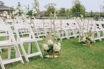 Outdoor wedding ceremony arranged with white flower decorations at Sebasco Harbor Resort