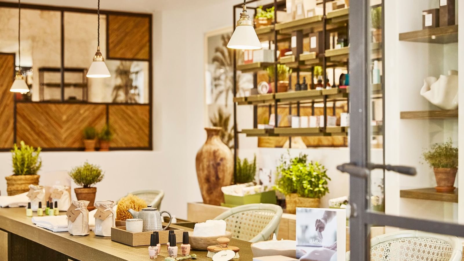 Spa reception counter with products and small pendant lights hanging over the display area at the Marbella Club