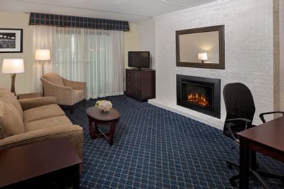 Couch & fireplace in 2 Room Double Bed Suite at Boxboro Regency