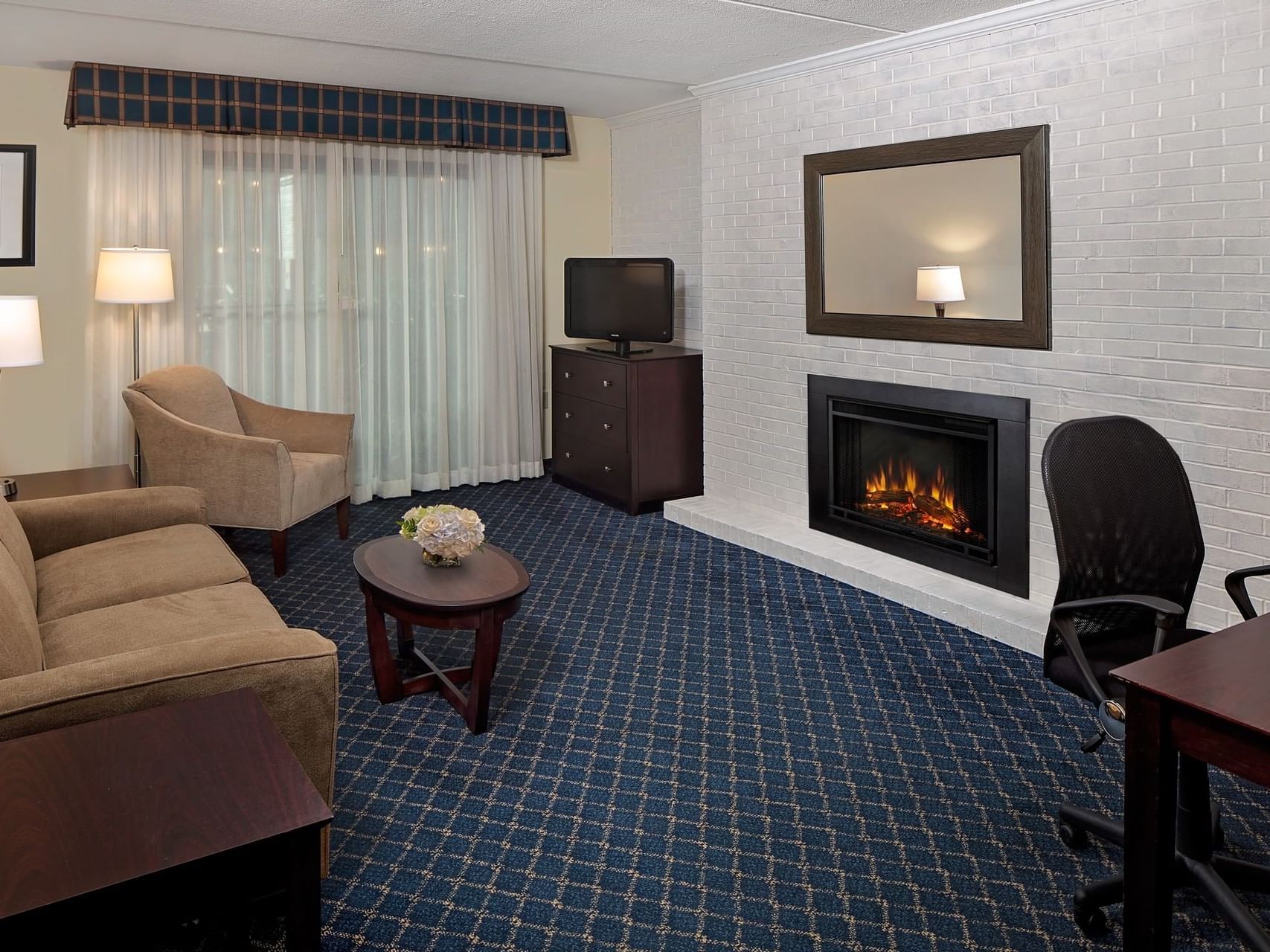 Couch & fireplace in 2 Room Double Bed Suite at Boxboro Regency