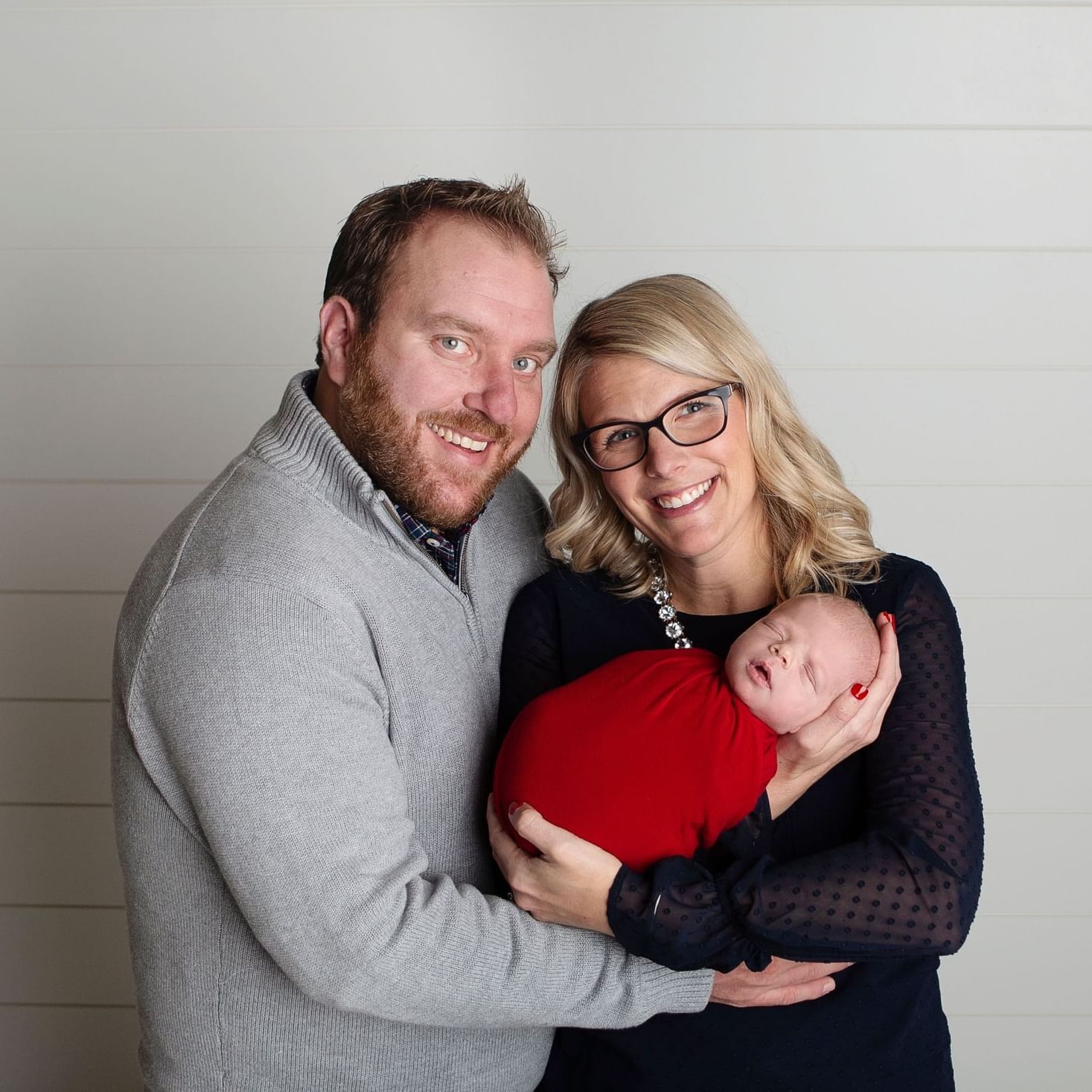 Portrait of a couple & their baby at Stein Eriksen Residences