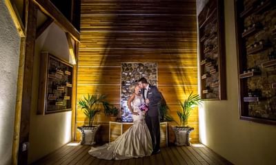 Newly-weds embracing & posing for a photo at The Wilshire Grand Hotel