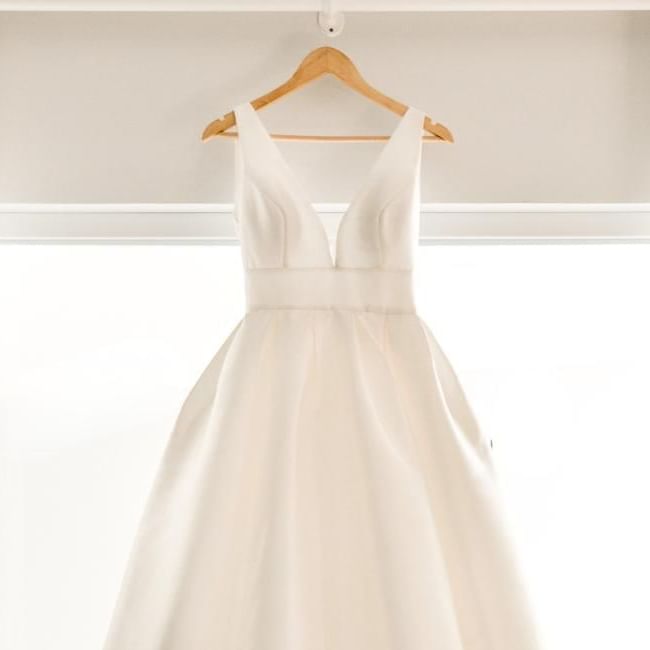 Beautiful wedding dress on hanger as featured in our article 