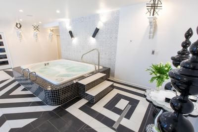 Indoor spa area featuring a hot tub and patterned flooring in The Crooked Cabana at The Roxbury