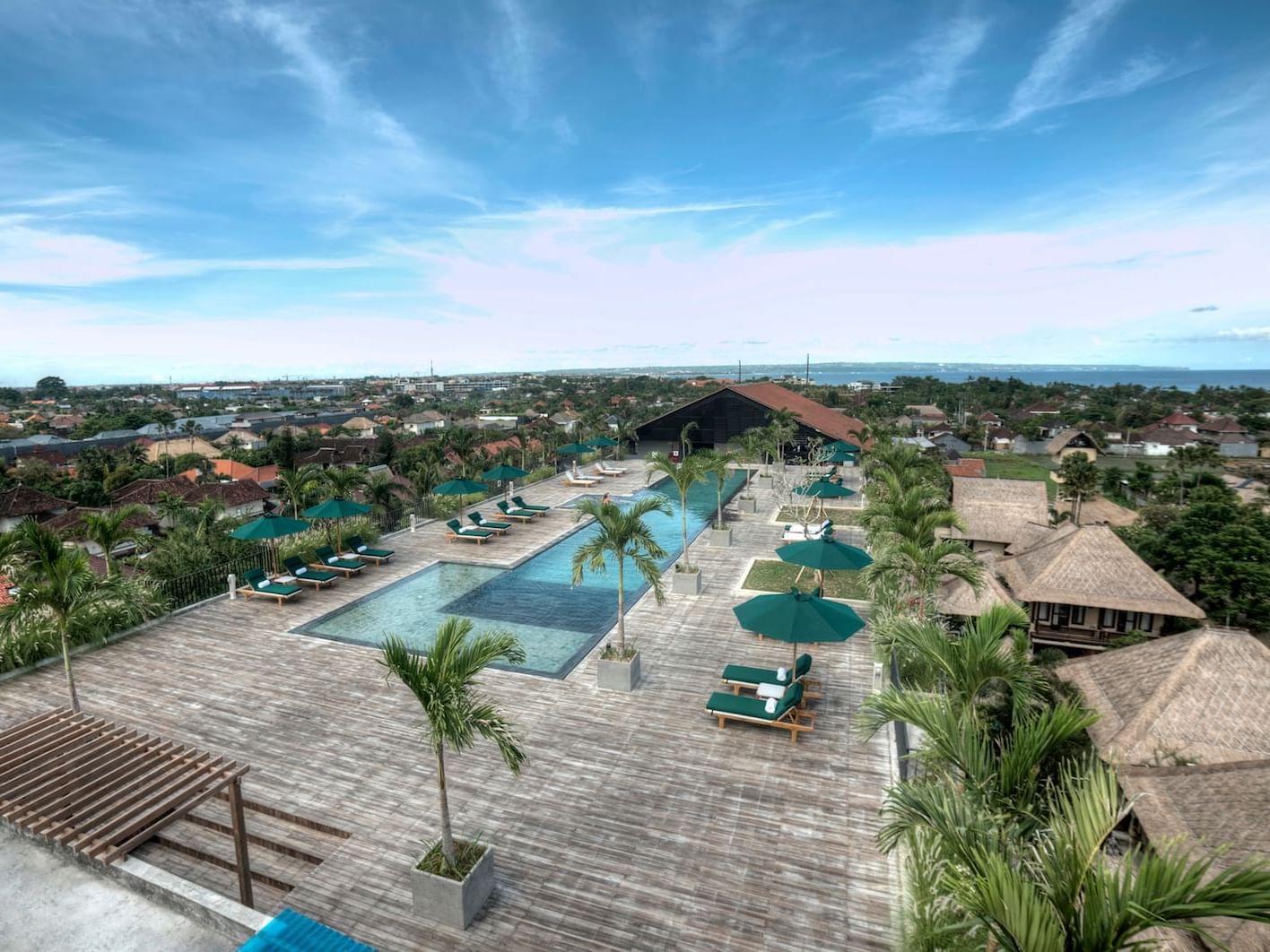 Swimming Pool surrounded by palm trees at U Hotels and Resorts