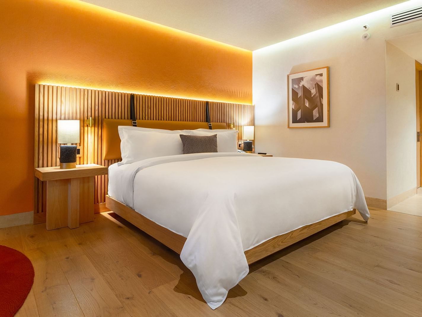 King Superior Camino Real Club Garden View with a wooden headboard and warm orange wall at Camino Real Polanco Mexico