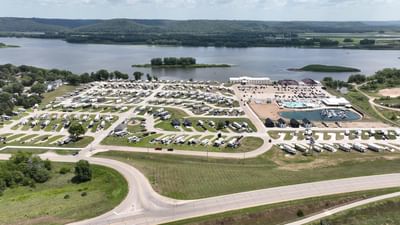 Aerial view of a spacious RV park with numerous parked trailers and vehicles at Off Shore Resort