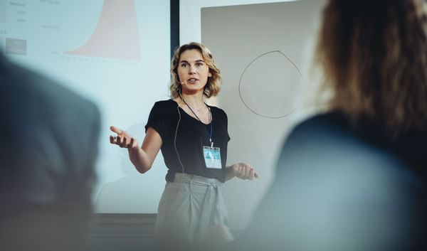 Woman presenting in a Coast Events Assured meeting