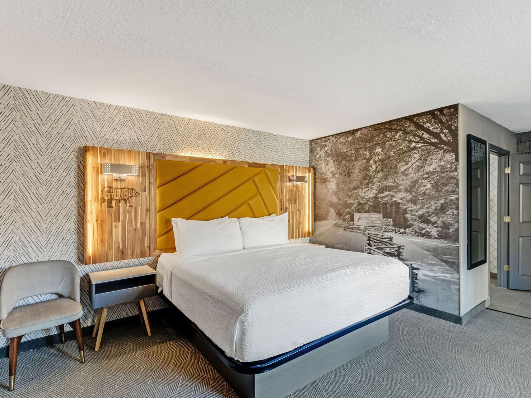 Large Bed with a nightstand in 1 King Standard at the Wander Hotel