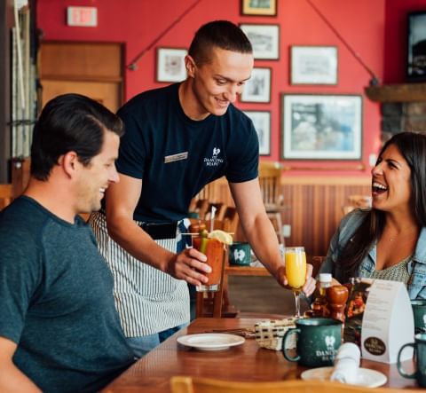 A waiter serving beverages at The Dancing Bears