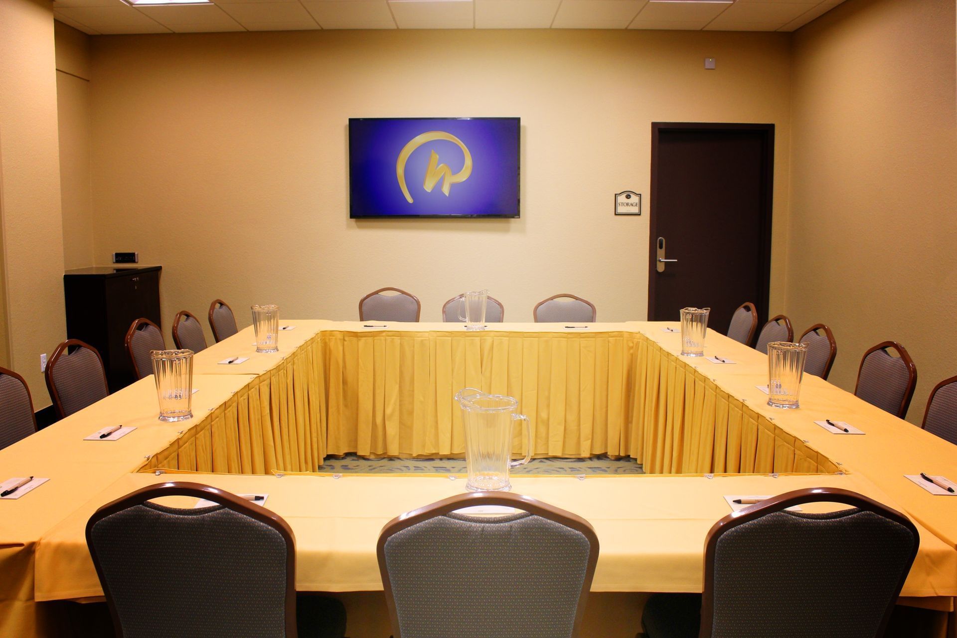 A conference room with a large table and chairs