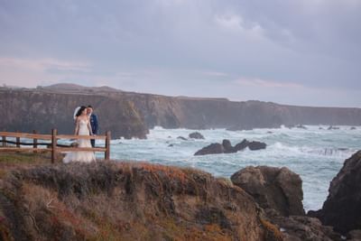 Wide angle of couple at the coastline of Heritage House Resort