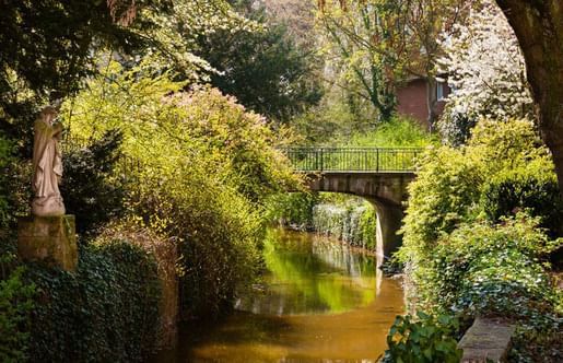 View of a bridge and river near The Mauritzhof Hotel Münster