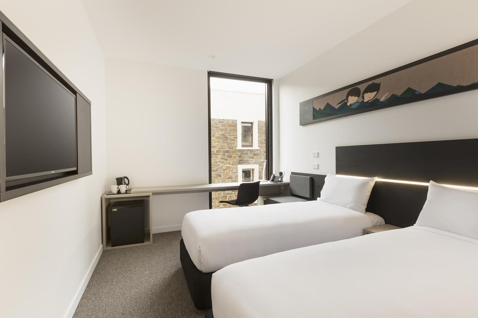 TV facing two beds and workspace by the window in Standard Room Two Single Beds at Ibis Adelaide