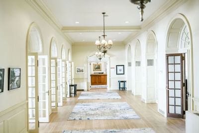 Beautifully lit hallway with archways and a polished wood floor at The Exeter Inn