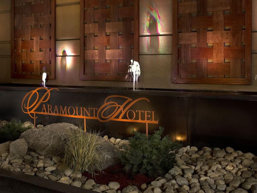 The elegant fountain at the entrance of The Paramount Hotel Seattle with the hotel's logo and artistic wooden panels