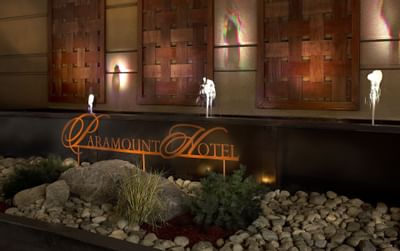 The elegant fountain at the entrance of The Paramount Hotel Seattle with the hotel's logo and artistic wooden panels