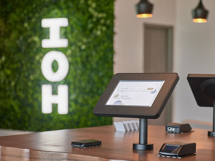 A digital Check-in tab on a desk at IOH Freestyle Hotels
