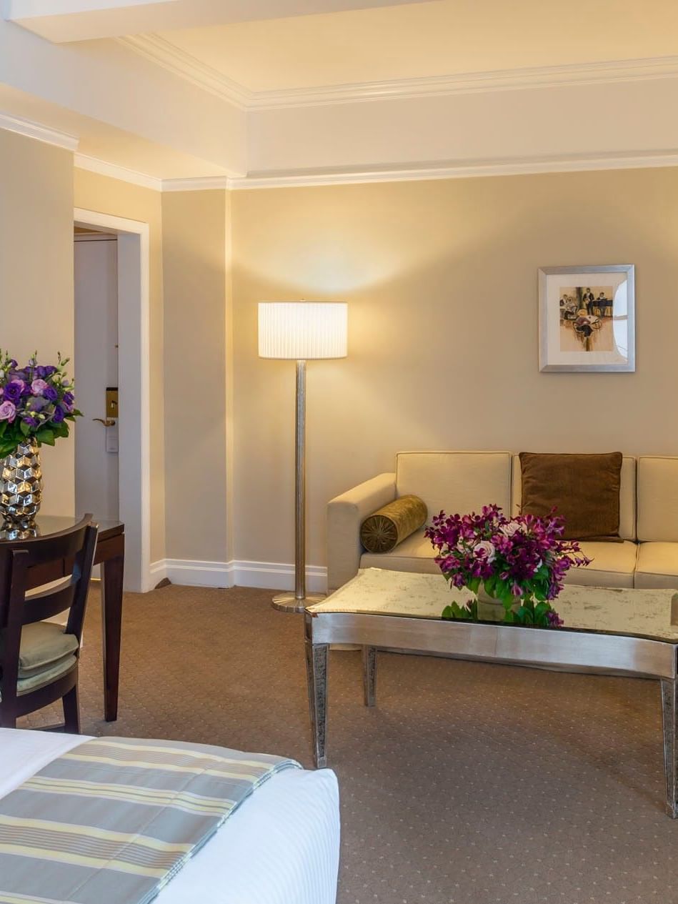 Cream sofa & table, and fresh purple floral bouquet with work desk in Premier City View with Terrace at Warwick New York