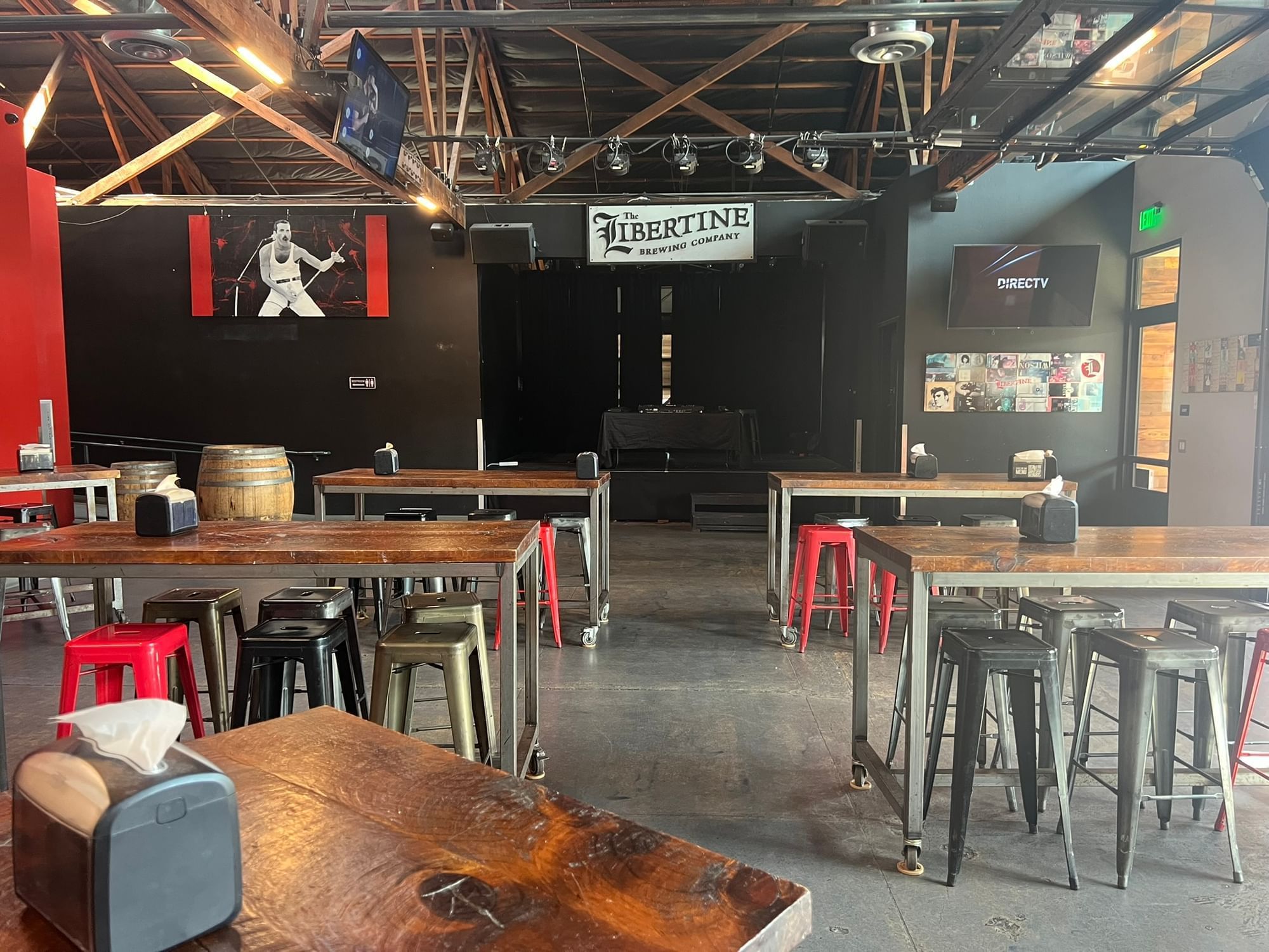 Libertine Brewing Company interior stage with high tables and stools