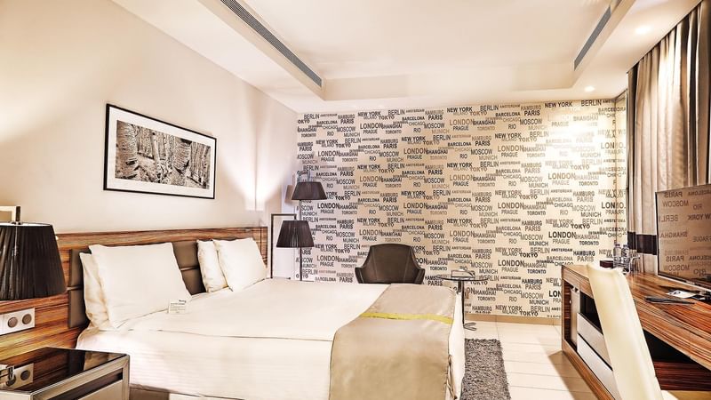 Deluxe Bedroom with a bed table and a chair at Warwick Stone 55 - Beirut