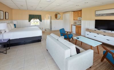 TV lounge by the bed in Poolhouse Studio at Breezeway Boutique Hotel