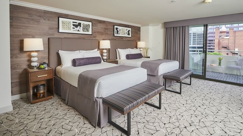 2 Cozy beds with side tables and balcony in Deluxe Double Room at Warwick Denver