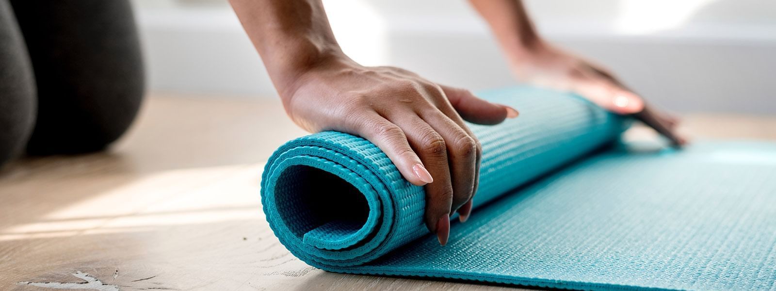 Close-up of Rolling a yoga mat at Crown Hotels