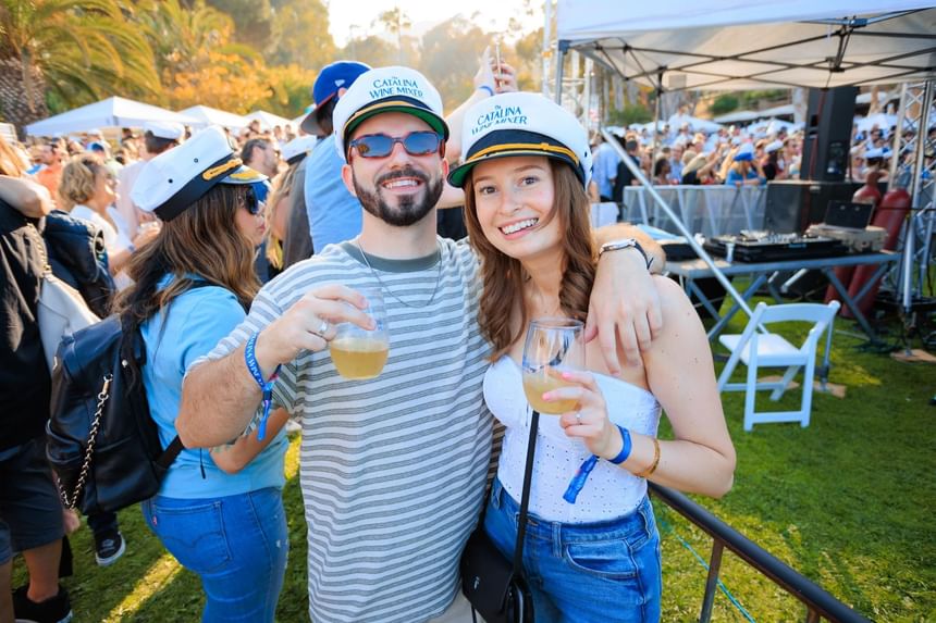 Couple with wine posing by the Catalina Wine Mixer near Catalina Island luxury hotels