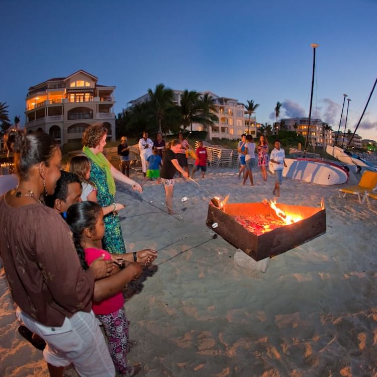 People by the Bonfire by the beach at The Somerset On Grace Bay