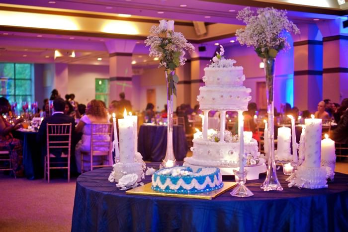 A wedding cake in a ballroom at Kellogg Conference Center