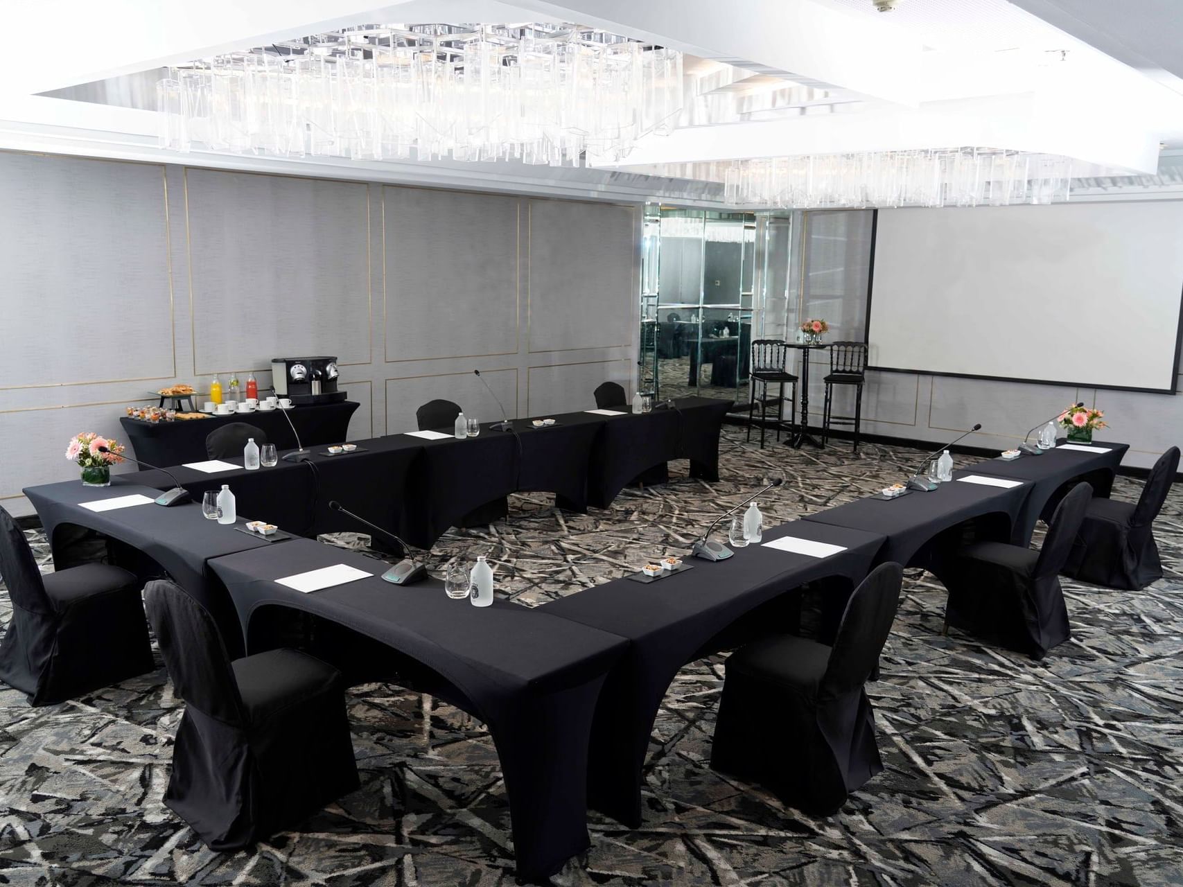 De La Castellana meeting room arranged with black tables and chairs at Hotel Emperador Buenos Aires