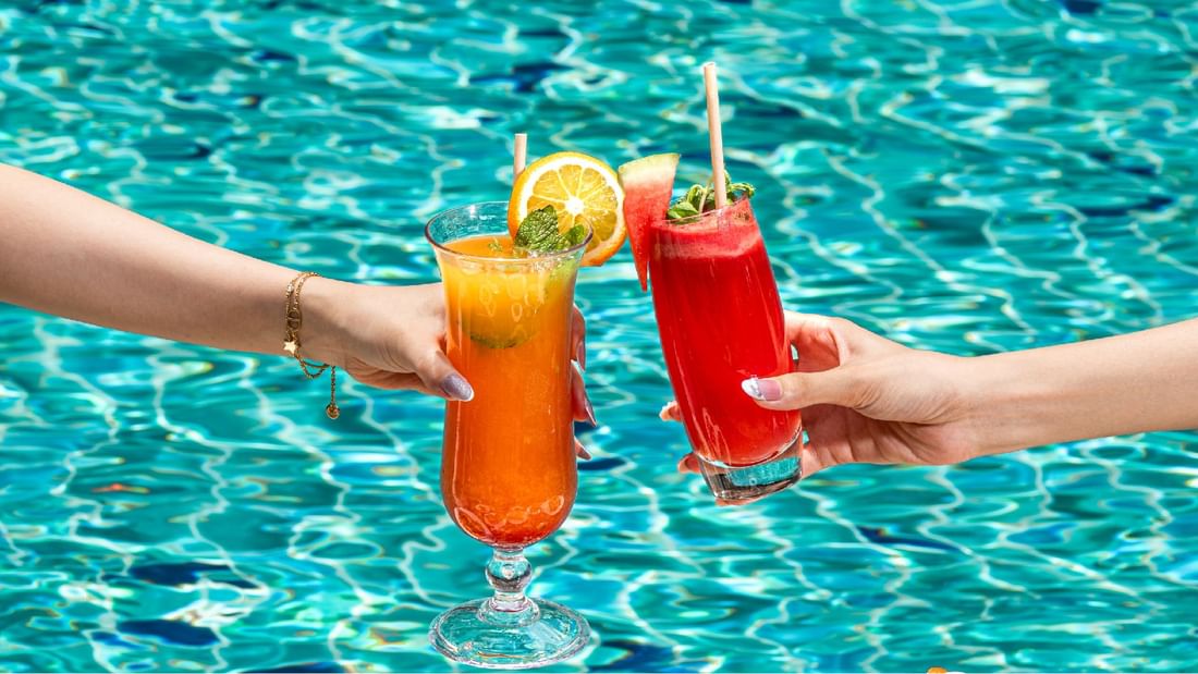 Two people are toasting drinks at Sunway Resort