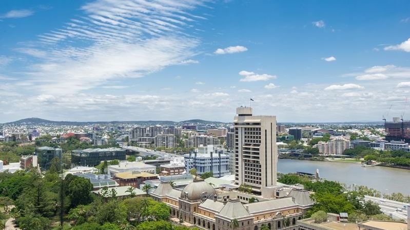 Aerial view of urban cityscape with historic buildings, modern towers, and river under blue sky at StudentLiving - on Margaret