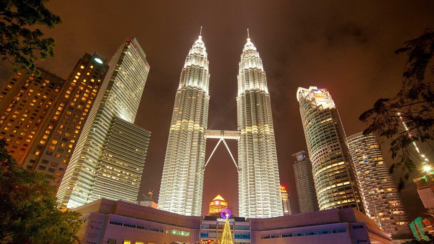 Petronas twin towers at night near Sunway Hotel Pyramid
