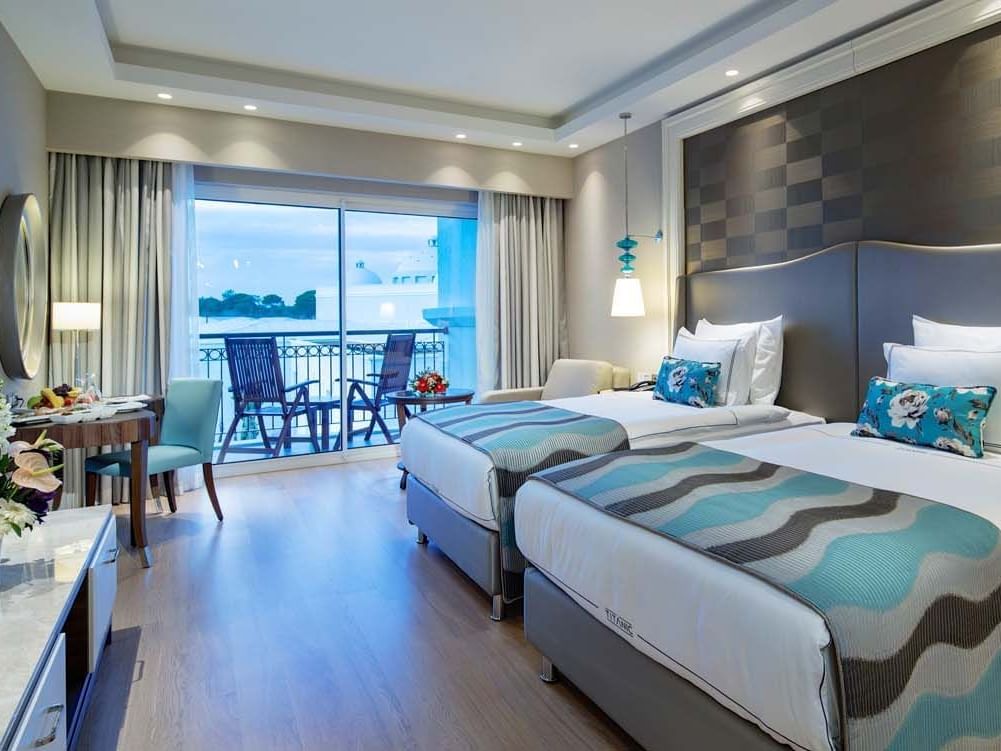 Work desk facing the beds in Family Suite with wooden floors at Titanic Deluxe Golf Belek