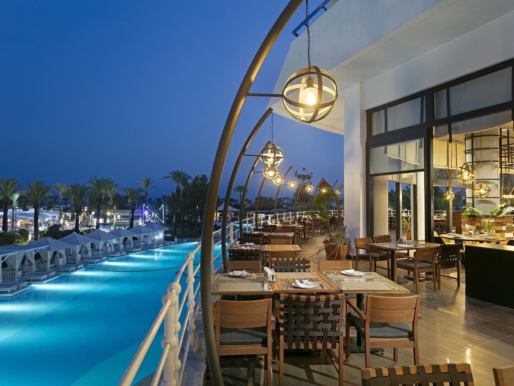 An outdoor dining table arrangement in Beef Grill Club at Titanic Deluxe Lara