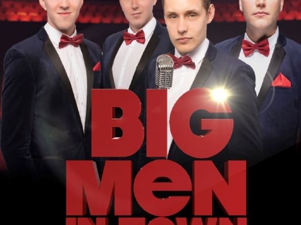 Four men in tuxedos and red bow ties stand in front of a microphone with 