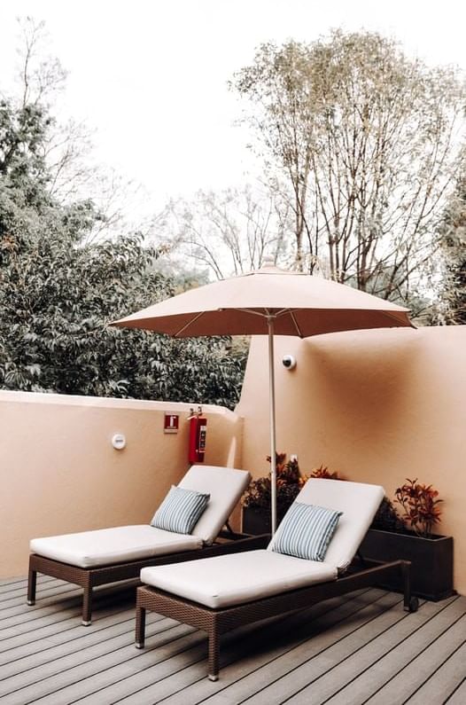 Sunbeds & umbrella in a Patio at Casa Mali by Dominion