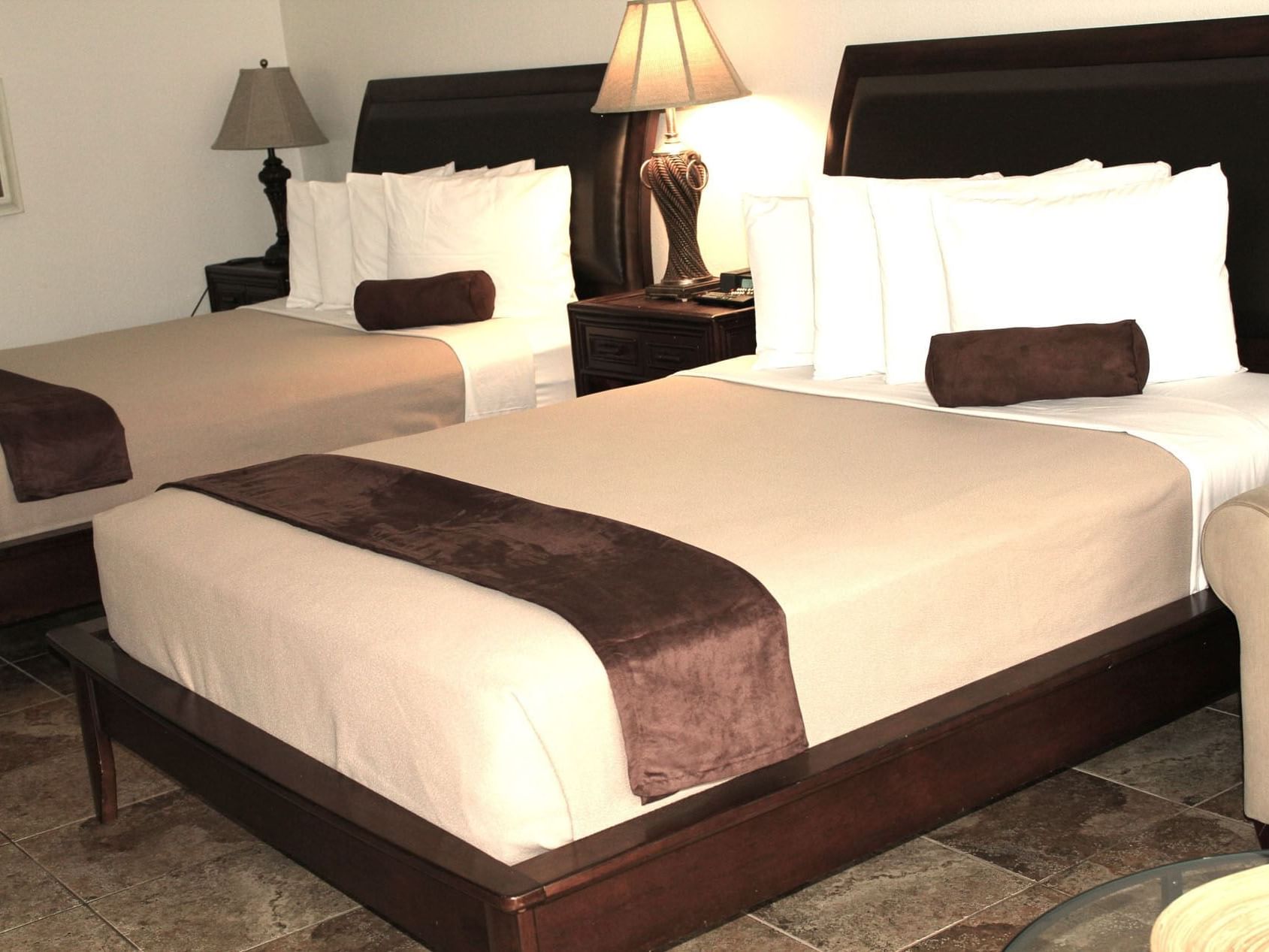 Two queen beds with nightstands in the Royal Palms Suite at Ocean Lodge Boca Raton