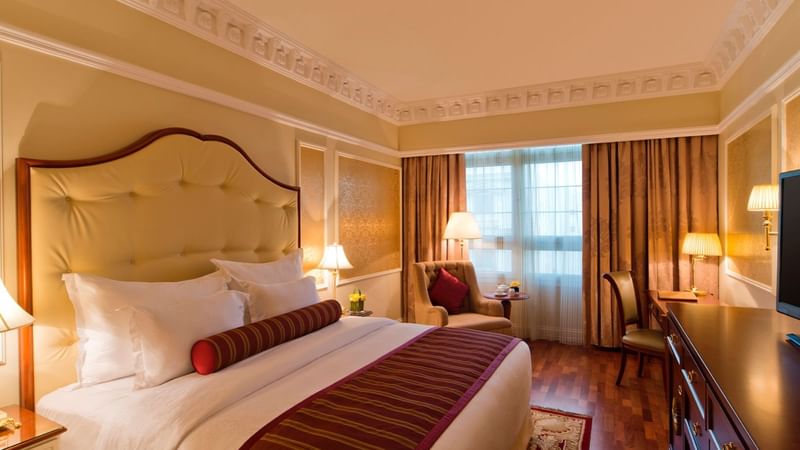 TV & work desk facing king bed in Deluxe Room at Warwick Doha