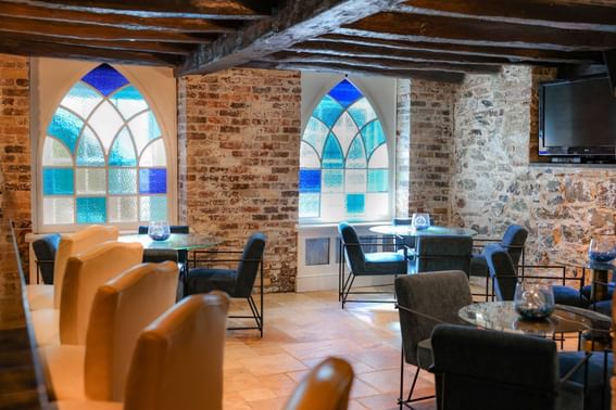 Dining area with round tables, chairs and TV at willow grove events, the inn at Willow grove