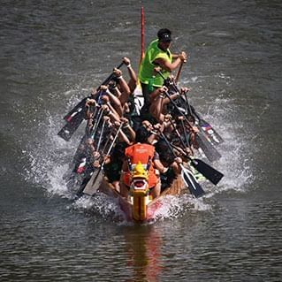 A front view of a dragon boat during the penang international dragon boat festival race.