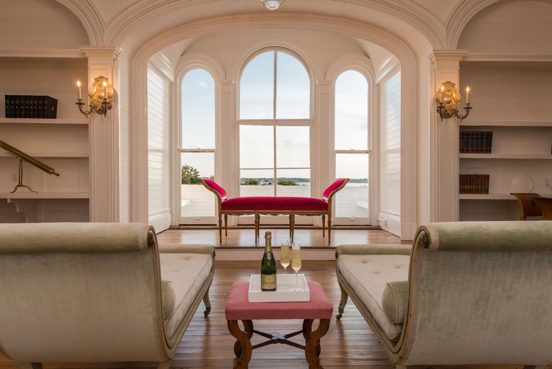 Two couches and a table with champagne at Hay Creek Hotels