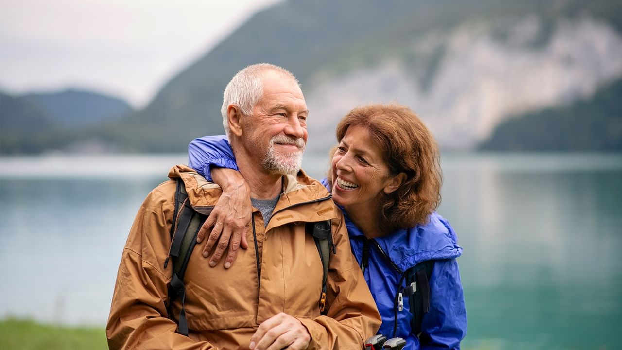 senior couple hiking by a lake