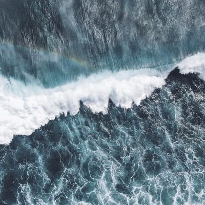 Aerial view of rough waves in the sea near Falkensteiner Hotels