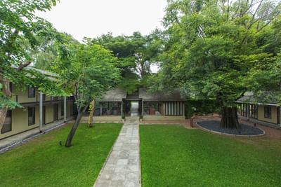 Courtyard with green trees at U INCHANTREE KANCHANABURI